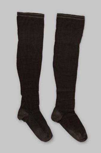 Stocking of Solid Shiny Dark Brown or Black Cotton Knit with an Embroidered Vertical Line at the Heel, Extending into a Flower