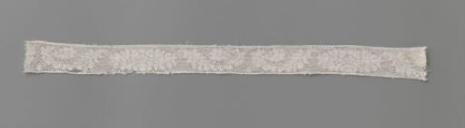 Strip of bobbin lace with peony between curved elongated leaves