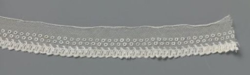 Strip of bobbin lace with two rows of open bobbins and a row of leaves