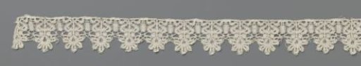 Strip of bobbin lace with palmette flower in a heart-shaped vase