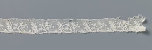 Strip of bobbin lace with a branch of starflowers and a thick branch with side branches