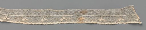 Strip of bobbin lace with hanging branch with three-lobed flower