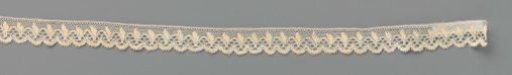Strip of bobbin lace with arches between which are small feathered leaves