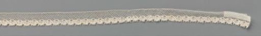 Strip of bobbin lace with linked ovals along the lower edge