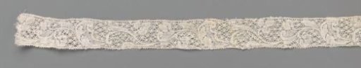 Strip of bobbin lace with a series of curved flower stems