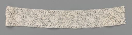 Strip of bobbin lace with a wave of a fan-shaped flower and feathered leaf