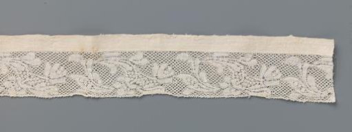 Insert of bobbin lace edge with two different kinds of flowers on a splitting stem