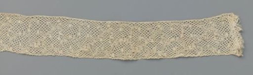 Strip of bobbin lace with very open vine with C-shaped splits and buds