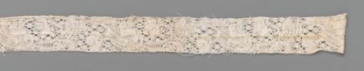 Strip of bobbin lace with thick curved leaves and three-lobed flowers
