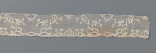 Strip of bobbin lace with trapezoidal fields divided by double vines