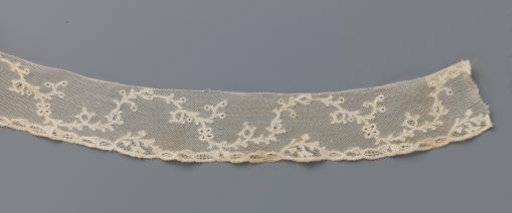 Strip of bobbin lace with a continuous wavy vine with berries and a butterfly
