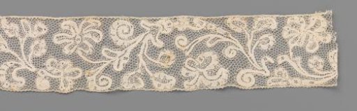 Strip of bobbin lace with wavy vines and palmette flowers