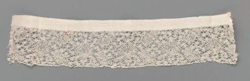 Strip of bobbin lace with oblique ovals and hearts with drops