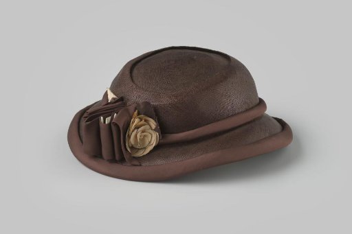 Hat of brown straw with corsage