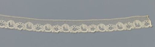 Strip of bobbin lace with pearl strings and ovals