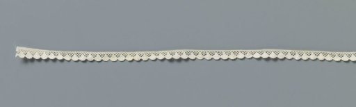 Strip of machine-made lace with fan motifs forming the shell border