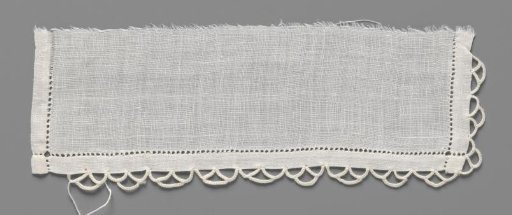 Cuff of linen batiste finished on three sides with open hems and a scalloped edge of crocheted lace