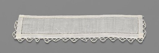 Cuff of linen batiste finished on three sides with open hems and a scalloped edge of crocheted lace