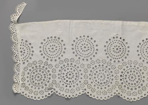 Strip of cotton with lace embroidery featuring openwork concentric circles