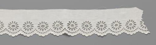 Cotton strip with lace embroidery of a continuous 'string of pearls' of openwork circles along the scalloped edge and an oval daisy above each scallop