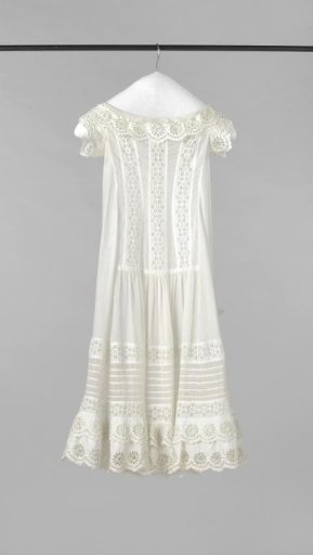 Japanese garment with front fastening of eight buttons and smooth-applied strip as sleeve of batiste with inserts of English embroidery; skirt front smooth, back loosely gathered as a train