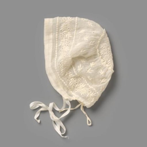 Girl's cap of batiste, decorated with plumetis embroidery in a scattered motif of leaves and leafy vines, the main motif running between two knotted borders