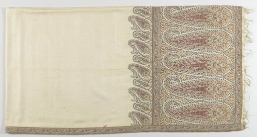 Long scarf with an ecru ground, at the short end ten elongated upright bota motifs in red and blue and a narrow applied border with a pattern of ornaments along the entire border