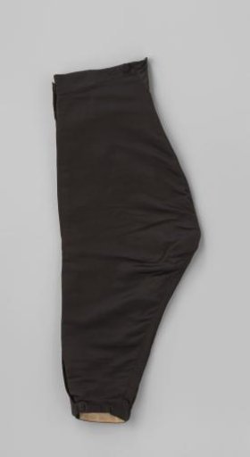 Knee breeches of black silk, with two side pockets, a small change pocket on the right, fabric buttons and fastening with band and black buckle