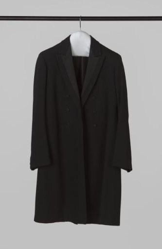 Long coat of woolen twill, lying collar with silk deep revers, double row of three diamond buttons and back in fan shape, with long split and two seams
