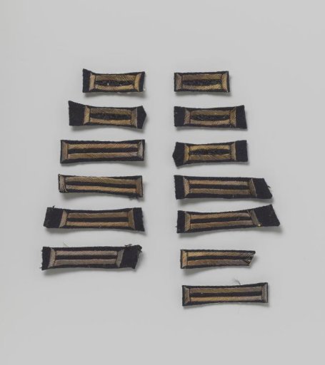 Cuffs or buttonholes of dark blue cloth, 13 pieces, around which is embroidered with silver thread