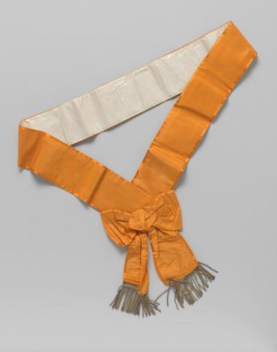 Sash or order ribbon (?) of bright orange taffeta, trimmed with satin and decorated with silver tassels or end fringes of narrow torsades