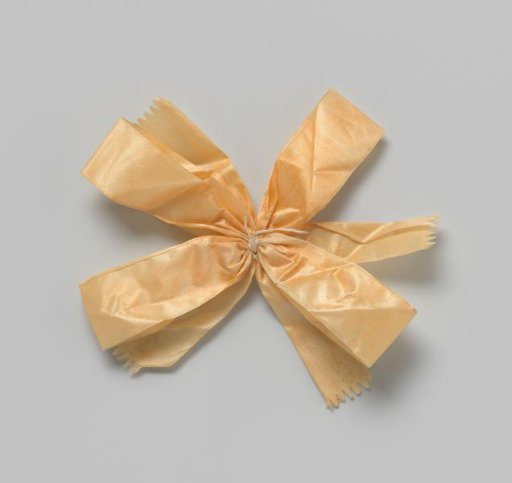 Hat rosette of narrow orange satin ribbon, with four loops and four scalloped ends