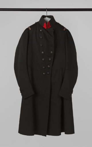 Tailored jacket with round bell-shaped skirt, standing collar, double row of silvered buttons with wall crown, silver shoulder straps and epaulettes, and red patch on collar, part of a civic guard uniform