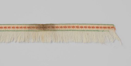 Passementerie consisting of a band of woven white wool, unpicked on one of the long sides to create a fringe; the decoration consists of rosettes embroidered in silk
