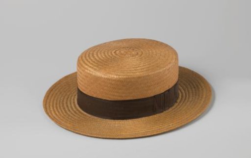 Straw hat with black band pleated and fastened