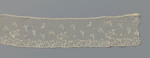 Strip of appliqué lace with ovals and bellflowers on a sparse vine along the lower edge