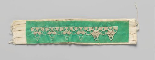 Pricking with needle lace pattern on green-coloured parchment for a shell strip of needle lace