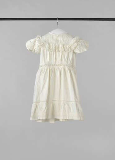 Dress for a child of white checkered cotton, decorated with gathering and English embroidery.