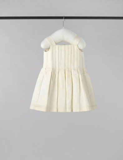 Underdress with back closure and ribbon ties of white piqué with a waffle pattern; label: V.E.