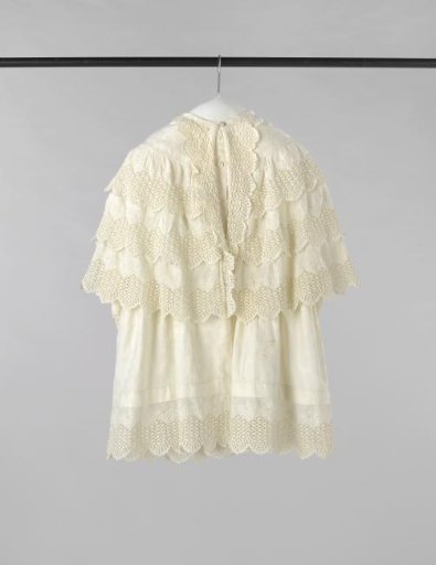 Carriage jacket, for boys and girls, of cotton damask provided with a triple pelerine of strips of English embroidery