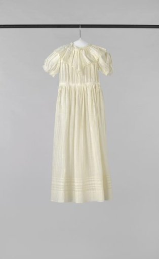 Girls' dress of openwork net fabric with a striped effect, decorated with a fixed collar of embroidered cotton