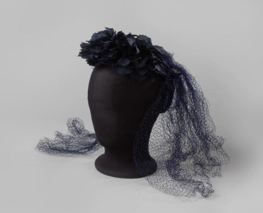 Bonnet-coiffure of navy blue flowers of silk and velvet, trimmed with blue voile, on an iron wire frame in horseshoe shape