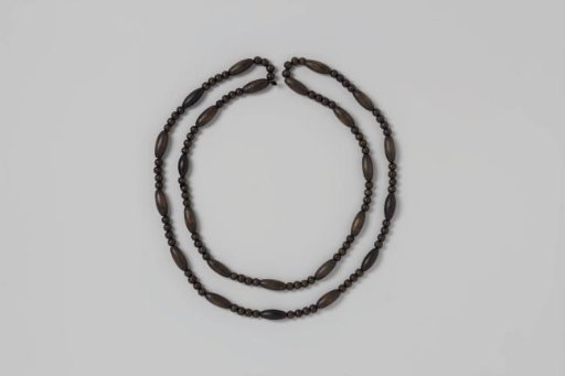 Necklace of black wooden beads, alternating four round and one oval