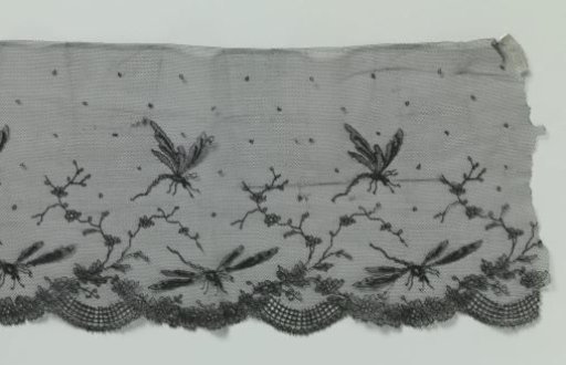 Strip of black machine-made lace with dragonflies