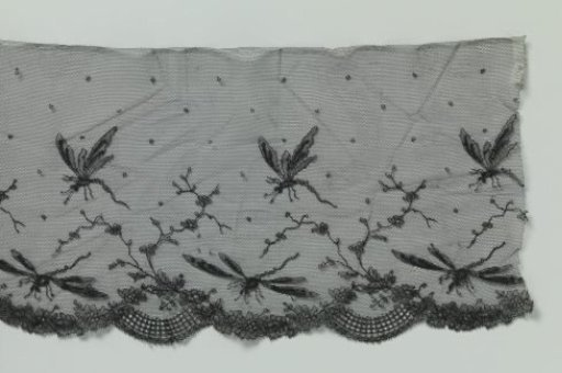 Strip of black machine-made lace with dragonflies