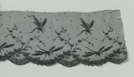 Strip of black machine-made lace with dragonflies
