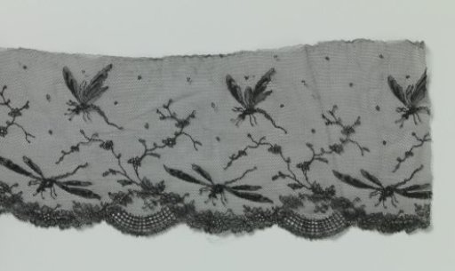 Strip of black machine-made lace with dragonflies