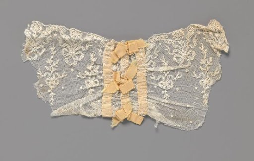 Cuff of machine-made lace with bows and with edging and bows made with a light orange ribbon