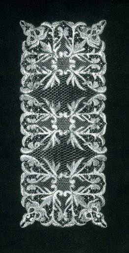 Lace design of a rectangular garment with elongated leaf volute motifs in white ink on black card
