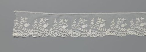 Strip of appliqué lace with C-shaped floral branch